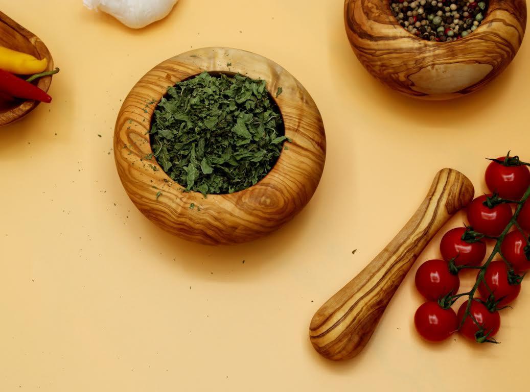 Handmade olive wood mortar and pestle with rustic Mediterranean grain, perfect for grinding spices, herbs, and nuts